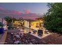 Stunning outdoor space with pool, patio seating, and beautiful desert landscaping at 4282 N 180Th Dr, Goodyear, AZ 85395