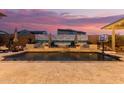 Beautiful backyard pool with water feature, basketball hoop, lounge chairs, and freshly laid travertine at 4282 N 180Th Dr, Goodyear, AZ 85395