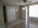 Bright living room with ceiling fan, tile floors, closet, and natural light at 430 W Santa Cruz Dr, Tempe, AZ 85282