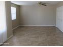 Living room has tile flooring, a ceiling fan, and a window at 430 W Santa Cruz Dr, Tempe, AZ 85282