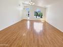 Spacious living room features gleaming wood floors and bright natural light at 4626 E Villa Rita Dr, Phoenix, AZ 85032