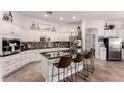 Bright kitchen featuring white cabinetry, granite countertops, island with seating, and stainless steel appliances at 4706 E Des Moines St, Mesa, AZ 85205