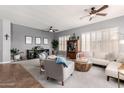 Spacious living room with neutral walls, plantation shutters, ceiling fan and comfortable seating at 4706 E Des Moines St, Mesa, AZ 85205