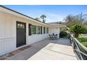 Inviting front patio features a black door, white brick, and a cozy seating area at 5339 E Osborn Rd, Phoenix, AZ 85018