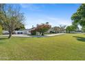 Expansive front lawn showcasing the beautiful white brick home with mature landscaping and blue sky at 5339 E Osborn Rd, Phoenix, AZ 85018