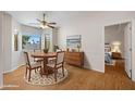 Charming dining room with a wooden table, four chairs, and natural light, perfect for Gathering meals and gatherings at 5830 E Mckellips Rd # 2, Mesa, AZ 85215
