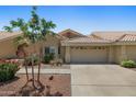 Charming single-story home featuring a tile roof, desert landscaping, and a two-car garage at 5830 E Mckellips Rd # 2, Mesa, AZ 85215