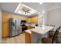 Modern kitchen features stainless steel appliances, sleek countertops, ample cabinet space, and a convenient breakfast bar at 5830 E Mckellips Rd # 2, Mesa, AZ 85215