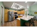 Bright kitchen features stainless steel appliances, an island with seating, and ample counter space at 5830 E Mckellips Rd # 2, Mesa, AZ 85215