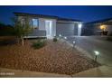 Charming single-story home featuring a well-manicured front yard with desert landscaping and a paved driveway at 6117 S Adelle --, Mesa, AZ 85212