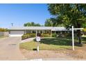 Well-kept single-story home featuring a manicured front yard, vibrant flower beds, and an attached garage at 7042 N 13Th St, Phoenix, AZ 85020