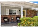 Inviting front porch with seating, decorative plants, and a view of the home's charming brick facade at 7042 N 13Th St, Phoenix, AZ 85020