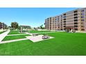 Beautiful condo complex common area with green grass, shaded benches and attractive landscaping at 7950 E Camelback Rd # 308, Scottsdale, AZ 85251