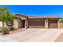 Beautiful single-story home showcasing a three-car garage and desert landscaping on a sunny day at 8418 W Palmaire Ave, Glendale, AZ 85305