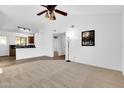 Inviting living room with neutral carpet, a ceiling fan, and an open floor plan at 921 W University Dr # 1023, Mesa, AZ 85201