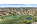 Stunning aerial view of the community showcasing lush golf courses and pristine lakes at 9826 W Tonto Ln, Peoria, AZ 85382