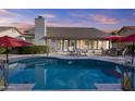 Beautiful backyard featuring a pristine pool, covered patio, and ample seating at 9826 W Tonto Ln, Peoria, AZ 85382