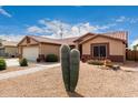 Single-story home featuring desert landscaping, two-car garage, and tiled roof, with brick walkway at 11133 E Dragoon Ave, Mesa, AZ 85208