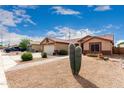 Single-story home featuring desert landscaping, two-car garage, and tiled roof, with brick walkway at 11133 E Dragoon Ave, Mesa, AZ 85208