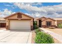 Charming single-story home featuring a two-car garage, desert landscaping, and a tiled roof at 11133 E Dragoon Ave, Mesa, AZ 85208