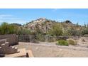 Fenced backyard with desert landscaping provides privacy and mountain views at 11856 E Parkview Ln, Scottsdale, AZ 85255