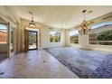 Inviting living room with decorative tile, chandelier, and a welcoming entrance at 11856 E Parkview Ln, Scottsdale, AZ 85255