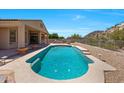 Tranquil pool nestled in the backyard with built in bar area, perfect for relaxation and entertainment at 11856 E Parkview Ln, Scottsdale, AZ 85255