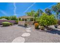 Serene backyard featuring a pergola, gravel, and stone walkways, creating a peaceful retreat at 13305 W Colter St, Litchfield Park, AZ 85340