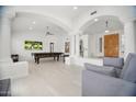 Open-concept living space with high ceilings, tile floors, and white walls and trim at 13629 N 71St Dr, Peoria, AZ 85381