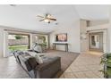 Bright living room featuring tile floors, a ceiling fan, and sliding glass doors to the backyard at 14821 N 42Nd St, Phoenix, AZ 85032