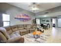 Spacious living room with a sectional sofa and open access to the dining area at 16836 E Mirage Crossing Ct # B, Fountain Hills, AZ 85268