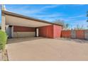 Spacious carport and extra parking area with a privacy wall at 1811 E Aurelius Ave, Phoenix, AZ 85020