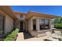 Inviting home entrance with stone accents and a charming arched doorway on a sunny day at 19058 N Aztec Point Dr, Surprise, AZ 85387