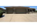 Exterior of the home featuring a three-car garage with a large driveway at 19058 N Aztec Point Dr, Surprise, AZ 85387