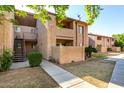A well-maintained two-story condo complex with stucco walls, private balconies, and landscaped grounds at 1942 S Emerson -- # 219, Mesa, AZ 85210