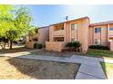 A two-story condo featuring well-maintained landscaping, stucco walls, and private balconies for each unit at 1942 S Emerson -- # 219, Mesa, AZ 85210