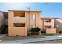A two-story condo showcasing private balconies, palm trees, and easy access to walkways and shared outdoor areas at 1942 S Emerson -- # 219, Mesa, AZ 85210