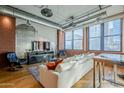 Open concept living area with modern decor, hardwood floors, and exposed ductwork at 21 E 6Th St # 311, Tempe, AZ 85281