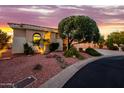 Well-maintained home featuring manicured landscaping, desert rock and native plants surrounding a welcoming exterior at 22318 N Pico Ct, Sun City West, AZ 85375