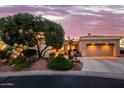 Charming exterior with a desert landscaped front yard and a two-car garage, creating excellent curb appeal at 22318 N Pico Ct, Sun City West, AZ 85375