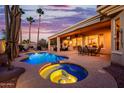 Inviting pool and spa with swaying palm trees create a serene backyard oasis for relaxation and entertainment at 22318 N Pico Ct, Sun City West, AZ 85375