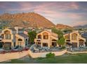 Beautiful view of home exterior with patio, mountain views, and well manicured landscaping at 25150 N Windy Walk Dr # 37, Scottsdale, AZ 85255