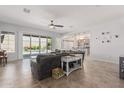 Living room with sliding doors to pool, barn doors, and a seamless connection to kitchen at 28623 N 66Th Ave, Phoenix, AZ 85083