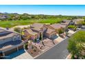 Expansive home situated on a golf course lot featuring mature landscaping, desert flora, and a three-car garage at 3601 N Sonoran Hts, Mesa, AZ 85207