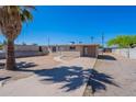 Inviting single-story home featuring a long driveway, desert landscaping, and neutral color scheme at 3946 W Monte Vista Rd, Phoenix, AZ 85009