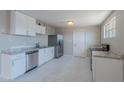 Bright kitchen featuring white cabinets, stainless steel appliances, and stylish countertops at 3946 W Monte Vista Rd, Phoenix, AZ 85009