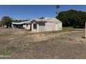 Side view of the home's exterior, revealing neutral siding and a compact yard at 3948 E Monterosa St, Phoenix, AZ 85018