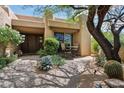 Inviting front entrance featuring a private courtyard, desert landscaping, and unique architecture at 40215 N 110Th Pl, Scottsdale, AZ 85262