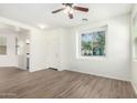 Sunlit living room with modern wood-look floors and neutral decor, offers a versatile layout at 4149 E Devon Dr, Gilbert, AZ 85296