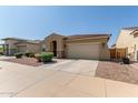 Single-story home with a red tile roof, desert landscaping, and an attached two-car garage at 5612 N 109Th Ave, Phoenix, AZ 85037